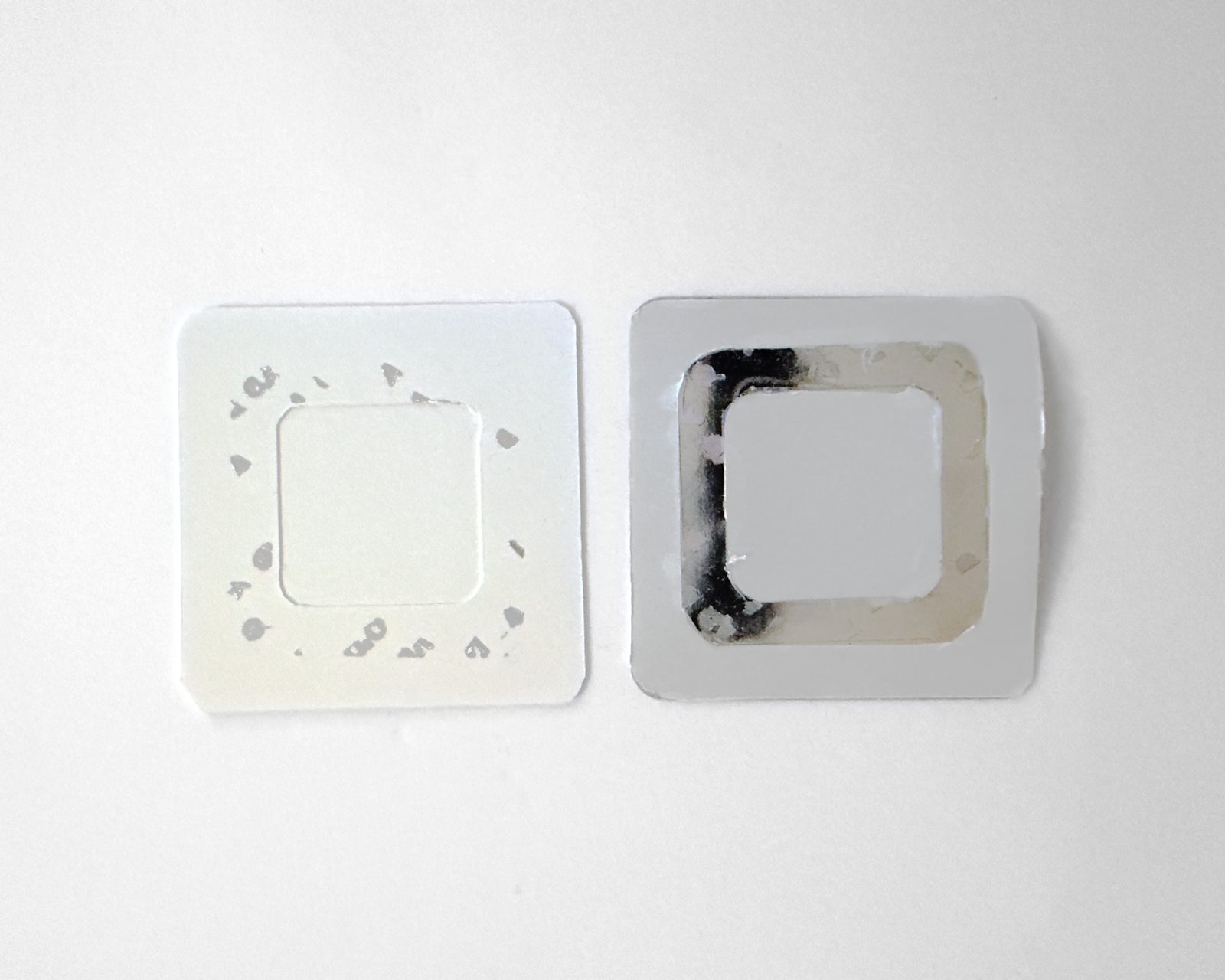 Both inner faces of an opened pouch showing the VOID tamper-evident residue.