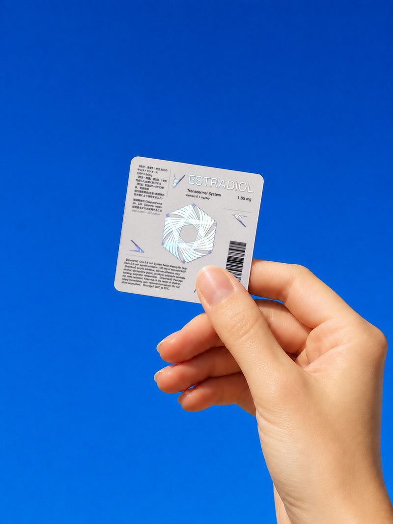 Estradiol pouch held against a bright blue sky